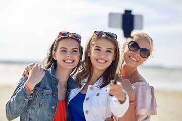 Image showing group of smiling women taking selfie on beach