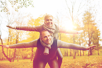 Image showing smiling couple having fun in autumn park