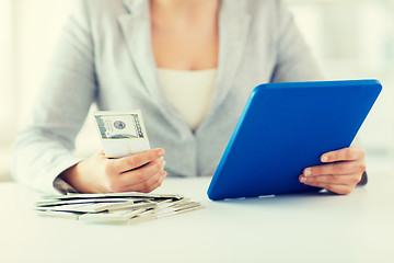 Image showing close up of woman hands with tablet pc and money