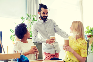 Image showing happy creative team drinking coffee in office