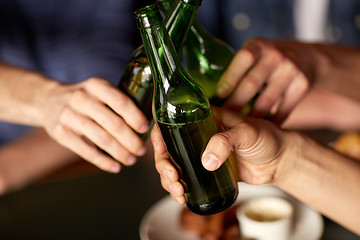 Image showing close up of friends drinking beer at bar or pub