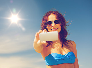 Image showing happy woman with phone on the beach