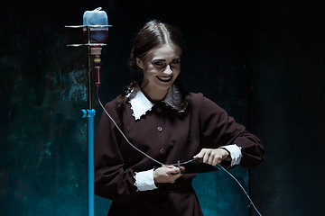 Image showing Portrait of a young girl in school uniform as killer woman