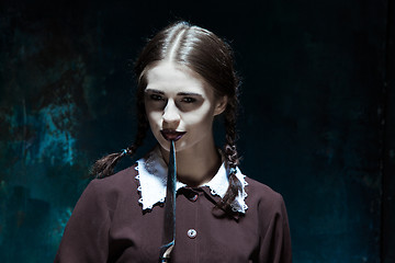 Image showing Portrait of a young girl in school uniform as killer woman