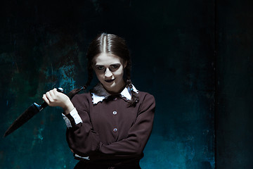 Image showing Portrait of a young girl in school uniform as killer woman