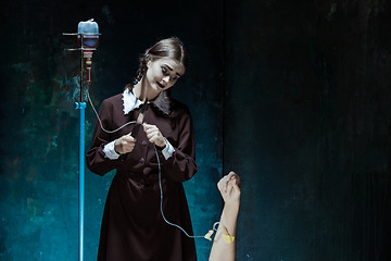 Image showing Portrait of a young girl in school uniform as killer woman