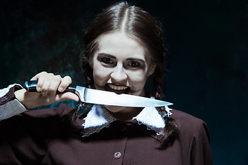 Image showing Portrait of a young girl in school uniform as killer woman