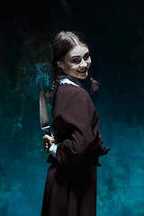 Image showing Portrait of a young girl in school uniform as killer woman