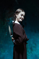 Image showing Portrait of a young girl in school uniform as killer woman