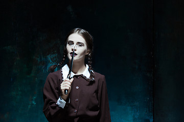 Image showing Portrait of a young girl in school uniform as killer woman