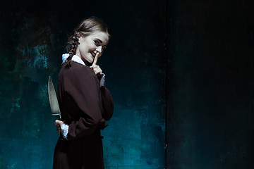 Image showing Portrait of a young girl in school uniform as killer woman