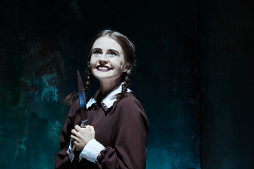 Image showing Portrait of a young girl in school uniform as killer woman