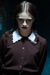 Image showing Portrait of a young girl in school uniform as killer woman