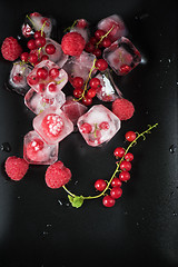 Image showing Frozen berries on wooden table