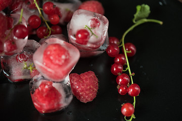 Image showing Frozen berries on wooden table