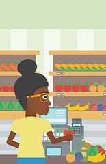 Image showing Cashier standing at the checkout in supermarket.