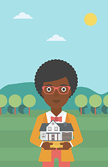 Image showing Woman holding house model vector illustration.