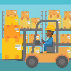 Image showing Warehouse worker moving load by forklift truck.