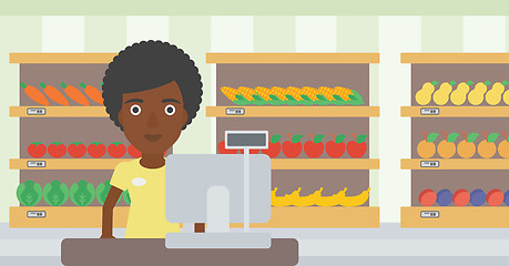 Image showing Cashier standing at the checkout in supermarket.