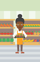 Image showing Supermarket worker with box full of apples.