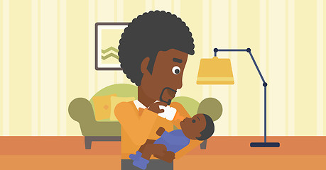 Image showing Father feeding baby.