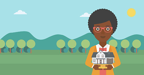 Image showing Woman holding house model vector illustration.