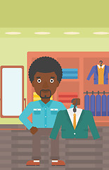 Image showing Man holding suit jacket in clothing store.