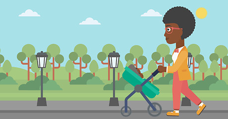 Image showing Mother walking with her baby in stroller.