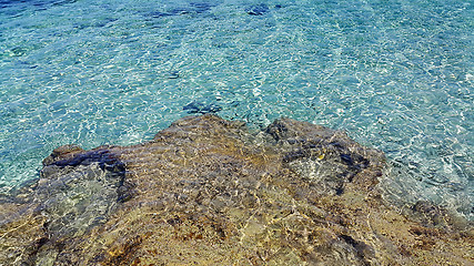 Image showing Bright sea water and coastal rocks