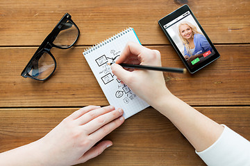 Image showing close up of woman or student writing to notepad