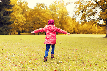 Image showing happy little girl having fun in autumn park