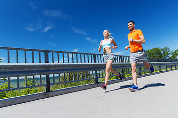 Image showing smiling couple running at summer seaside