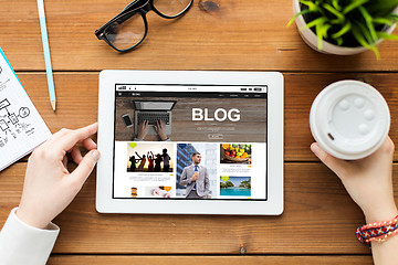 Image showing close up of woman with tablet pc on wooden table