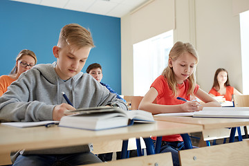 Image showing group of students with books writing school test