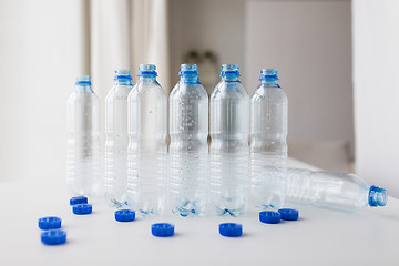 Image showing close up of empty water bottles and caps on table