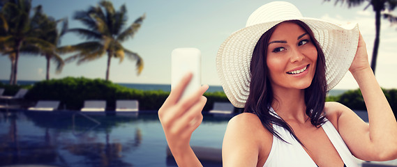 Image showing young woman taking selfie with smartphone