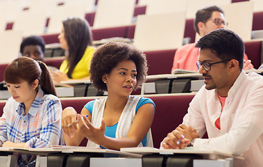 Image showing group of students with notebooks in lecture hall