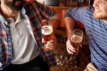 Image showing happy male friends drinking beer at bar or pub