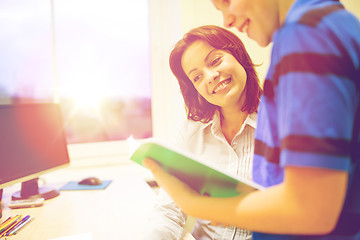 Image showing school boy with notebook and teacher in classroom