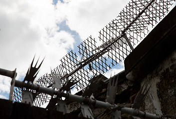 Image showing close up of fence with barbed wire and mesh