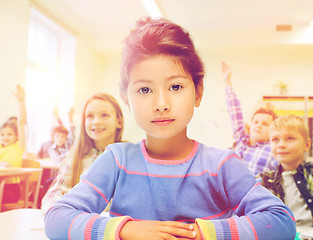 Image showing little school girl over classroom background