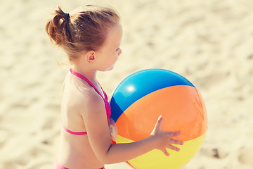 Image showing happy little girl playing inflatable ball on beach