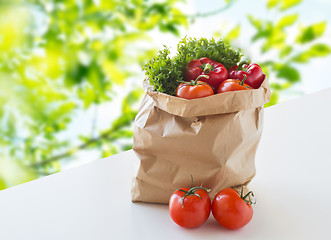 Image showing paper bag with fresh ripe vegetables on table