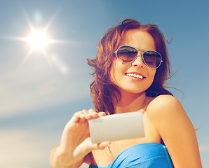 Image showing happy smiling woman using phone camera