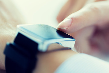 Image showing close up of hands setting smart watch