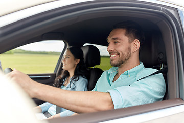 Image showing happy man and woman driving in car