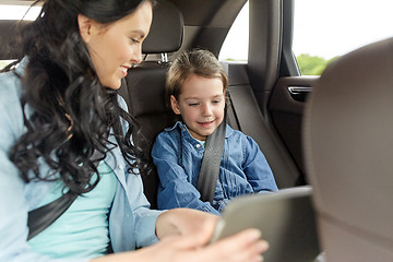 Image showing happy family with tablet pc driving in car