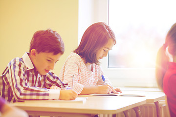 Image showing group of school kids writing test in classroom