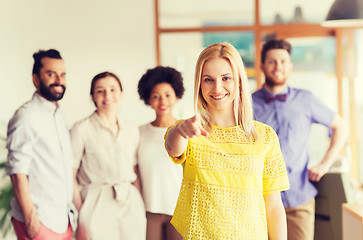 Image showing woman pointing to you over creative office team