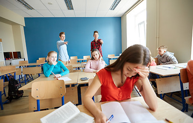 Image showing students gossiping behind classmate back at school